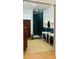 Bathroom featuring double sinks, green tiled shower, wooden floors and modern fixtures at 41 Pitt St, Charleston, SC 29401