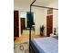 Bedroom with ensuite bath features a four-poster bed, dark wood flooring and decorative rug at 41 Pitt St, Charleston, SC 29401