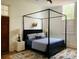 Bedroom featuring a four-poster bed, decorative rug and light-filled windows at 41 Pitt St, Charleston, SC 29401