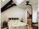 Cozy bedroom with a retro-themed bedspread, ceiling fan, and wooden beam detail at 41 Pitt St, Charleston, SC 29401