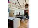 Open dining area with kitchen island and fireplace, plus high ceilings and second story balcony at 41 Pitt St, Charleston, SC 29401