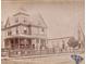 Vintage photo of a large two-story house with a covered porch, next to a building with arched windows at 41 Pitt St, Charleston, SC 29401