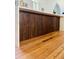 Elegant eat-in island features marble countertop, wood cabinetry and stainless steel appliances with hardwood floors at 41 Pitt St, Charleston, SC 29401