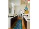 Bright kitchen features white marble countertops, dark wood cabinets, designer lighting, and a decorative runner rug at 41 Pitt St, Charleston, SC 29401