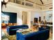 Bright, open floor plan with second-story balcony, dark blue sofas, and hardwood flooring at 41 Pitt St, Charleston, SC 29401