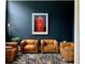 Sitting room showcases leather armchairs on a decorative rug against a navy wall with modern art at 41 Pitt St, Charleston, SC 29401