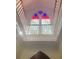 Bright lancet window with red and blue stained glass above staircase at 41 Pitt St, Charleston, SC 29401
