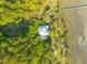 Bird's eye view of a pristine home with a metal roof surrounded by lush greenery and natural landscapes at 4386 Park Island Rd, Hollywood, SC 29449