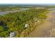 Aerial view of waterfront homes surrounded by marsh and lush forest at 4386 Park Island Rd, Hollywood, SC 29449