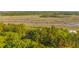 Aerial view featuring river meandering through the marsh and wooden dock near the home at 4386 Park Island Rd, Hollywood, SC 29449