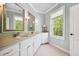 Well-lit bathroom with double vanities, granite countertops, and a large window for ample light at 4386 Park Island Rd, Hollywood, SC 29449