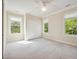 Bedroom with carpeted floor, ceiling fan, closet, and large windows at 4386 Park Island Rd, Hollywood, SC 29449