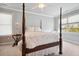 Charming bedroom featuring a four-poster bed, ample natural light, and scenic views at 4386 Park Island Rd, Hollywood, SC 29449