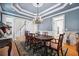 Dining room with coffered ceiling, chandelier, and access to other rooms with views outside at 4386 Park Island Rd, Hollywood, SC 29449