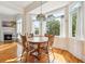 Sunlit dining area with large windows and a wood table, adjacent to the living area at 4386 Park Island Rd, Hollywood, SC 29449