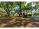 Charming two-story home surrounded by mature trees and lush foliage at 4386 Park Island Rd, Hollywood, SC 29449