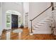 Grand foyer featuring a striking staircase, elegant flooring, and a front door with transom windows at 4386 Park Island Rd, Hollywood, SC 29449