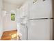 Bright laundry room with modern washer and dryer set, white cabinets and a hardwood floor at 4386 Park Island Rd, Hollywood, SC 29449