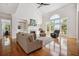 Bright living room featuring fireplace, hardwood floors, and large windows at 4386 Park Island Rd, Hollywood, SC 29449