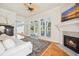 Cozy living room with a fireplace, wood floors and access to an outdoor patio at 4386 Park Island Rd, Hollywood, SC 29449