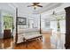Expansive main bedroom with hardwood floors, coffered ceilings, sitting area and a four-poster bed at 4386 Park Island Rd, Hollywood, SC 29449