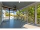 Comfortable screened porch featuring a ceiling fan and view of the surrounding landscape at 4386 Park Island Rd, Hollywood, SC 29449