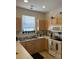 Functional kitchen featuring natural wood cabinets, laminate countertops, and ample natural light from a window at 4816 Cane Pole Ln, Summerville, SC 29485