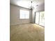 Bright living room with sliding glass doors and vintage chandelier, great for entertaining and relaxation at 4816 Cane Pole Ln, Summerville, SC 29485