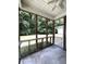 Screened porch with concrete floor and view of the tree-lined backyard at 4816 Cane Pole Ln, Summerville, SC 29485