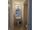 Cozy powder room with a pedestal sink, oval mirror, and tiled flooring, conveniently located for guests at 4816 Cane Pole Ln, Summerville, SC 29485