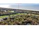 Scenic aerial view of the home surrounded by trees and a golf course near the ocean at 4947 Green Dolphin Way, Kiawah Island, SC 29455