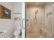 Luxurious bathroom featuring a tiled shower with glass door and built-in shelving at 4947 Green Dolphin Way, Kiawah Island, SC 29455