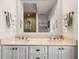 Elegant bathroom with dual sinks, white cabinetry, and a spacious mirror reflecting the tiled shower at 4947 Green Dolphin Way, Kiawah Island, SC 29455