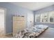 Inviting bedroom with soft blue walls, plantation shutters, and a cozy bed with a patterned comforter at 4947 Green Dolphin Way, Kiawah Island, SC 29455