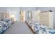 Well-lit bedroom with a cozy bed with coral print bedding and access to an ensuite bathroom at 4947 Green Dolphin Way, Kiawah Island, SC 29455