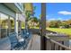 Outdoor deck with blue wicker chairs and scenic golf course views at 4947 Green Dolphin Way, Kiawah Island, SC 29455