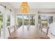Dining area with golf course views, sliding barn door, and decorative chandelier at 4947 Green Dolphin Way, Kiawah Island, SC 29455