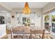 Open dining area with sliding barn door, views, and decorative chandelier at 4947 Green Dolphin Way, Kiawah Island, SC 29455