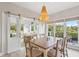 Open dining area with golf course views, sliding barn door, and decorative chandelier at 4947 Green Dolphin Way, Kiawah Island, SC 29455