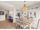 Dining area with stylish wooden chairs and view of the living room and kitchen at 4947 Green Dolphin Way, Kiawah Island, SC 29455