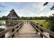 Rustic dock house with weathered wood, positioned at the end of a wooden pathway over grassy wetlands and waterway at 4947 Green Dolphin Way, Kiawah Island, SC 29455
