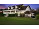 Inviting two-story residence with a sprawling front lawn, accentuated by a charming porch and well-manicured landscaping at 4947 Green Dolphin Way, Kiawah Island, SC 29455