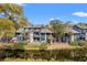 Exterior view of condo with a beautiful water view, private balconies, and mature landscaping at 4947 Green Dolphin Way, Kiawah Island, SC 29455