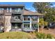View of condo's exterior featuring private balconies, lush landscaping, outdoor patio, and large windows at 4947 Green Dolphin Way, Kiawah Island, SC 29455