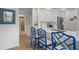 Bright kitchen features white cabinets, stainless appliances, and a breakfast bar with elegant blue chairs at 4947 Green Dolphin Way, Kiawah Island, SC 29455