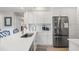 Well-lit kitchen with white cabinetry, stainless steel fridge, and a breakfast bar area providing ample counter space at 4947 Green Dolphin Way, Kiawah Island, SC 29455