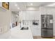 Modern kitchen with white cabinets, stainless steel refrigerator, and a convenient breakfast bar for casual dining at 4947 Green Dolphin Way, Kiawah Island, SC 29455
