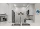 Modern kitchen showcases white cabinets, stainless steel appliances, and stylish decor with a clean, functional design at 4947 Green Dolphin Way, Kiawah Island, SC 29455