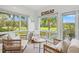 Bright sunroom boasts tranquil views, shiplap walls, and coastal decor, creating a serene and inviting space at 4947 Green Dolphin Way, Kiawah Island, SC 29455