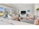 Comfortable living room with sliding doors, plush sofas, and a view of the beautifully landscaped exterior at 4947 Green Dolphin Way, Kiawah Island, SC 29455